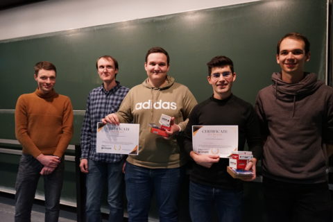 The winning team M&M at the award ceremony, holding their Coral AI Dev Boards.